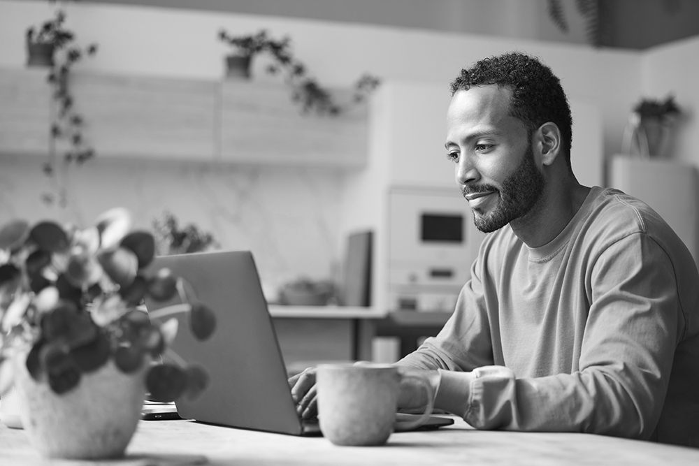 Man working on laptop at home representing eCOA innovations to streamline clinical trial processes