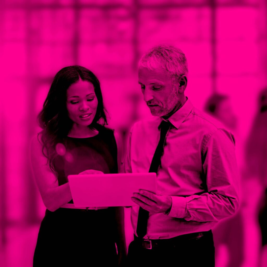 Collaborative Guidance in Clinical Trial Technology Business colleagues reviewing clinical trial technology strategies on a tablet, symbolizing collaboration and expert guidance.