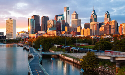 Sunset over the Philadelphia skyline and Schuylkill Banks Boardwalk, promoting YPrime’s appearance at OCT East Coast 2025. Visit booth #58 in King of Prussia, PA to explore clinical trial solutions.