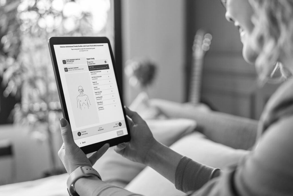 Woman viewing clinical trial joint assessment on a tablet using an eCOA system