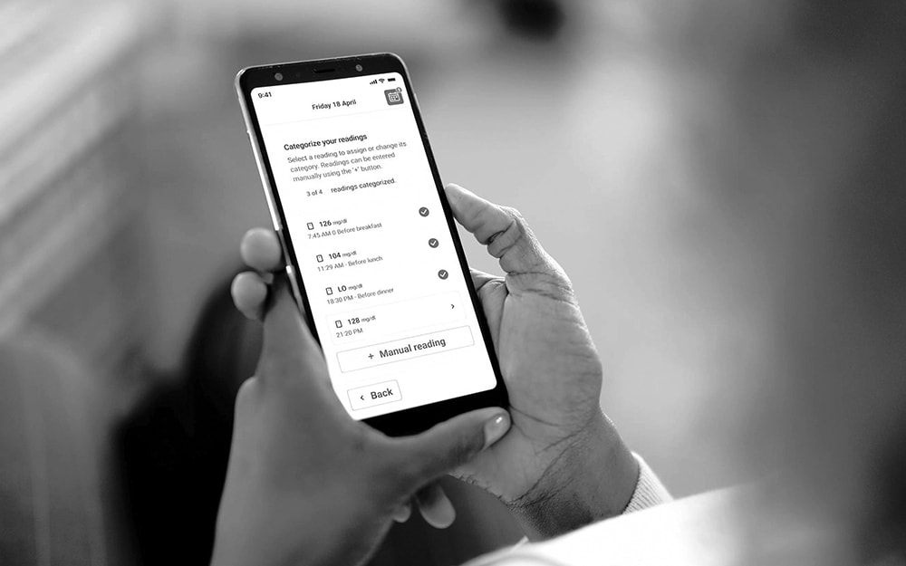 Close-up of a smartphone displaying glucose monitoring data, representing connected device use in GLP-1 clinical trials for real-time data capture and protocol compliance.