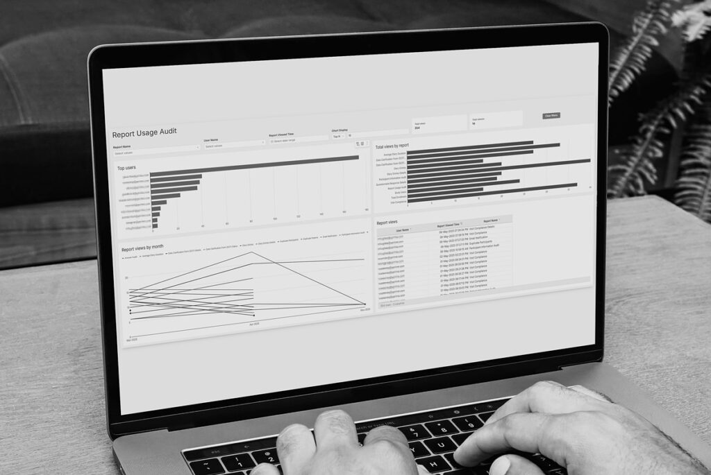 Man typing on computer displaying YPrime’s real-time, audit-ready eCOA reporting fact sheet.